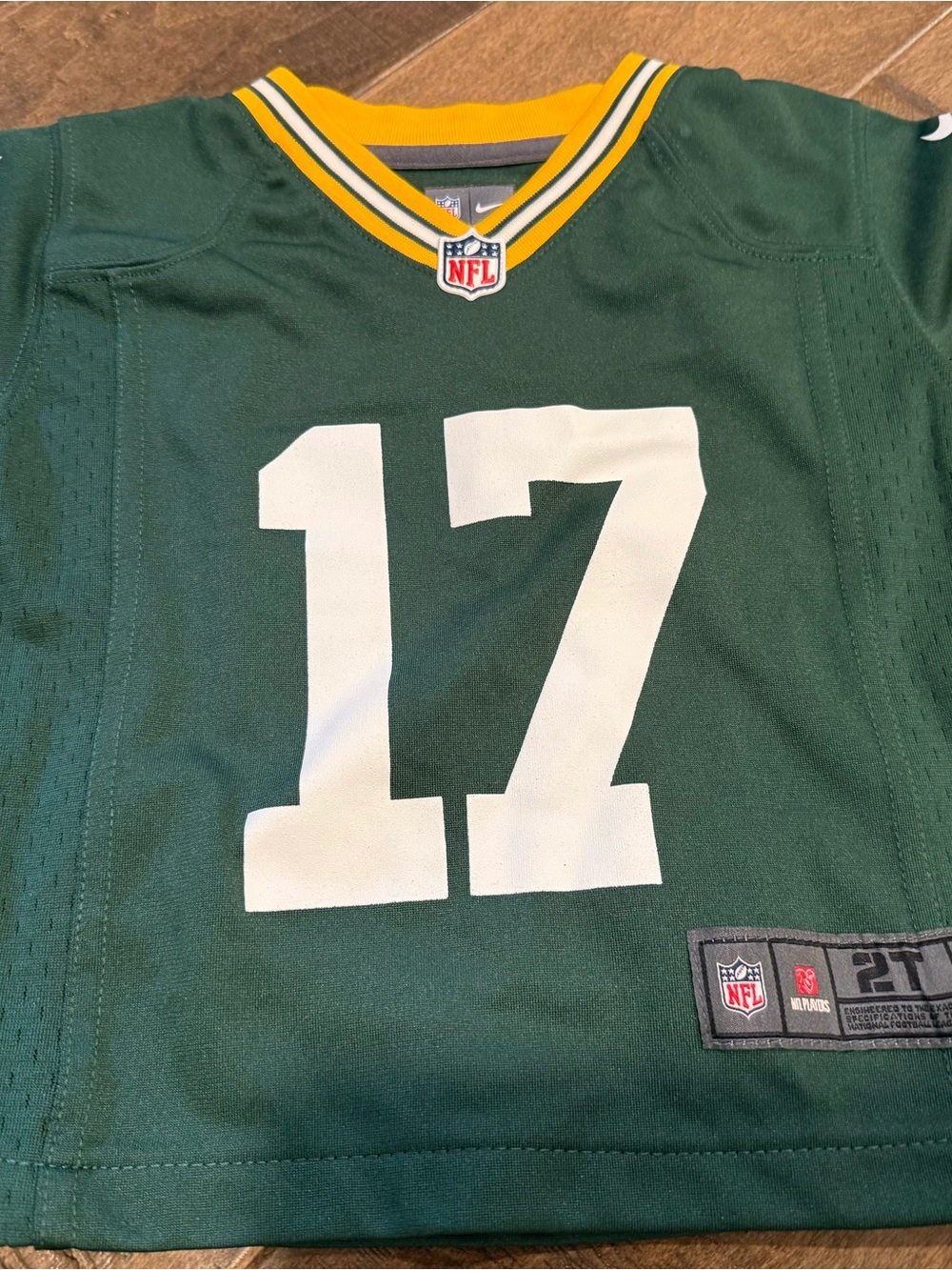 NFL Green Game Jersey Tag Detail with White and Red Logos